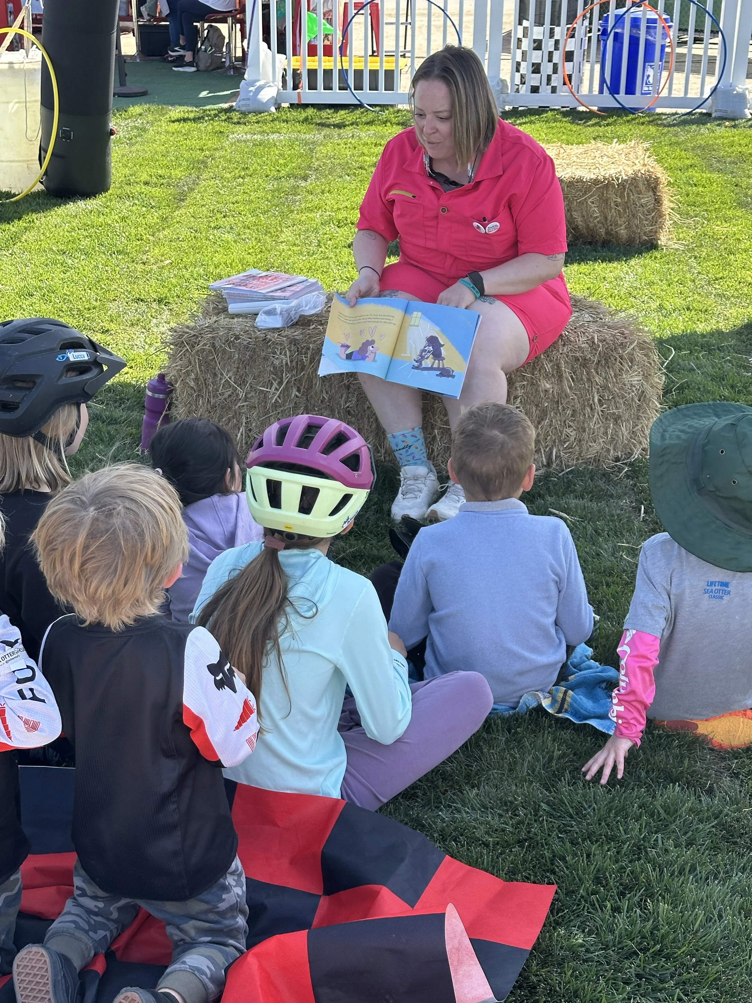 Marley Blonsky reading The Ragtag Best Friends Bicycle Club to a group of kids.