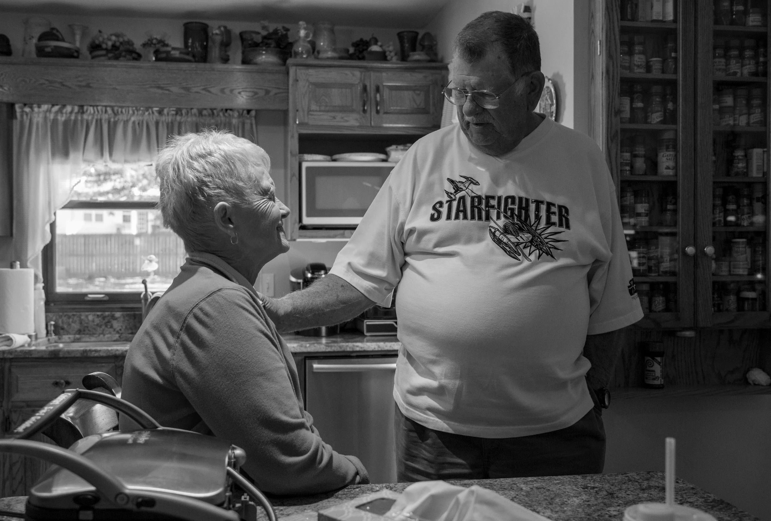 Jean and Tom share a moment in the kitchen of their home in Paducah. "It's been a real pleasure," Jean says of their 26 year marriage. Both were previously married and divorced before they met each other. "Being married before taught us how to make things work well," Tom said. They now work together to raise Bentley. "He thinks his papaw hung the moon," Jean says.