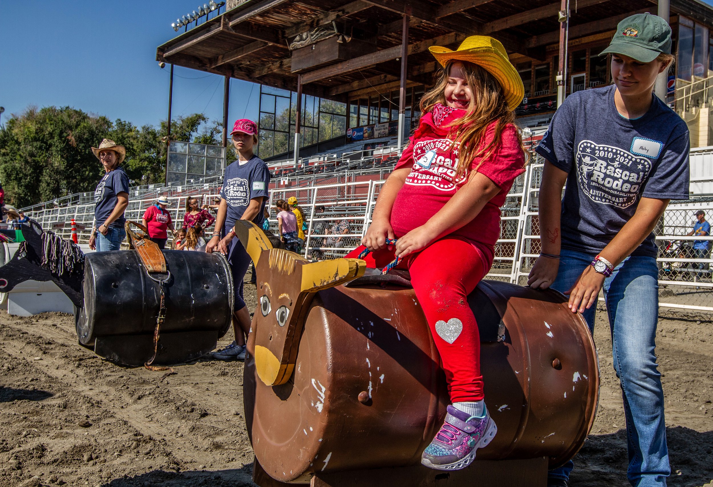  Mallory Burkhart, 5, laughs as she rides a rocking bull during the annual Rascal Rodeo at the Benton Franklin Fair &amp; Rodeo in Kennewick. The organization focuses on “helping those with physical and developmental disabilities discover unknown abi