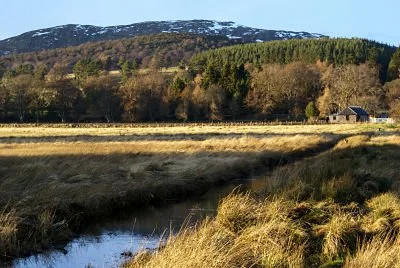 View across Insh Marshes towards the Cairngorm mountains from Railway Cottage, a self-catering cottage at Balavil.