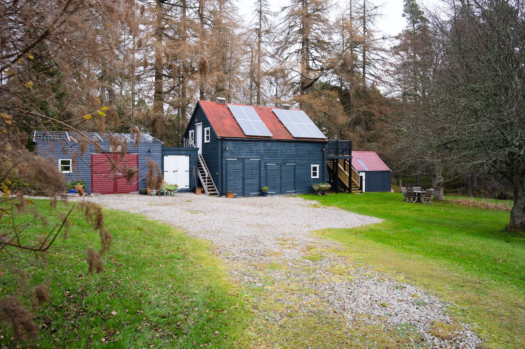 Exterior of The Hayloft showing its secluded setting among the trees at Rothiemurchus.