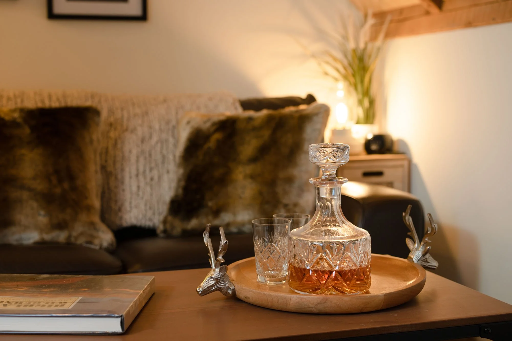 Whisky decanter and glasses in the living room, one of the cosy details inside The Hayloft.