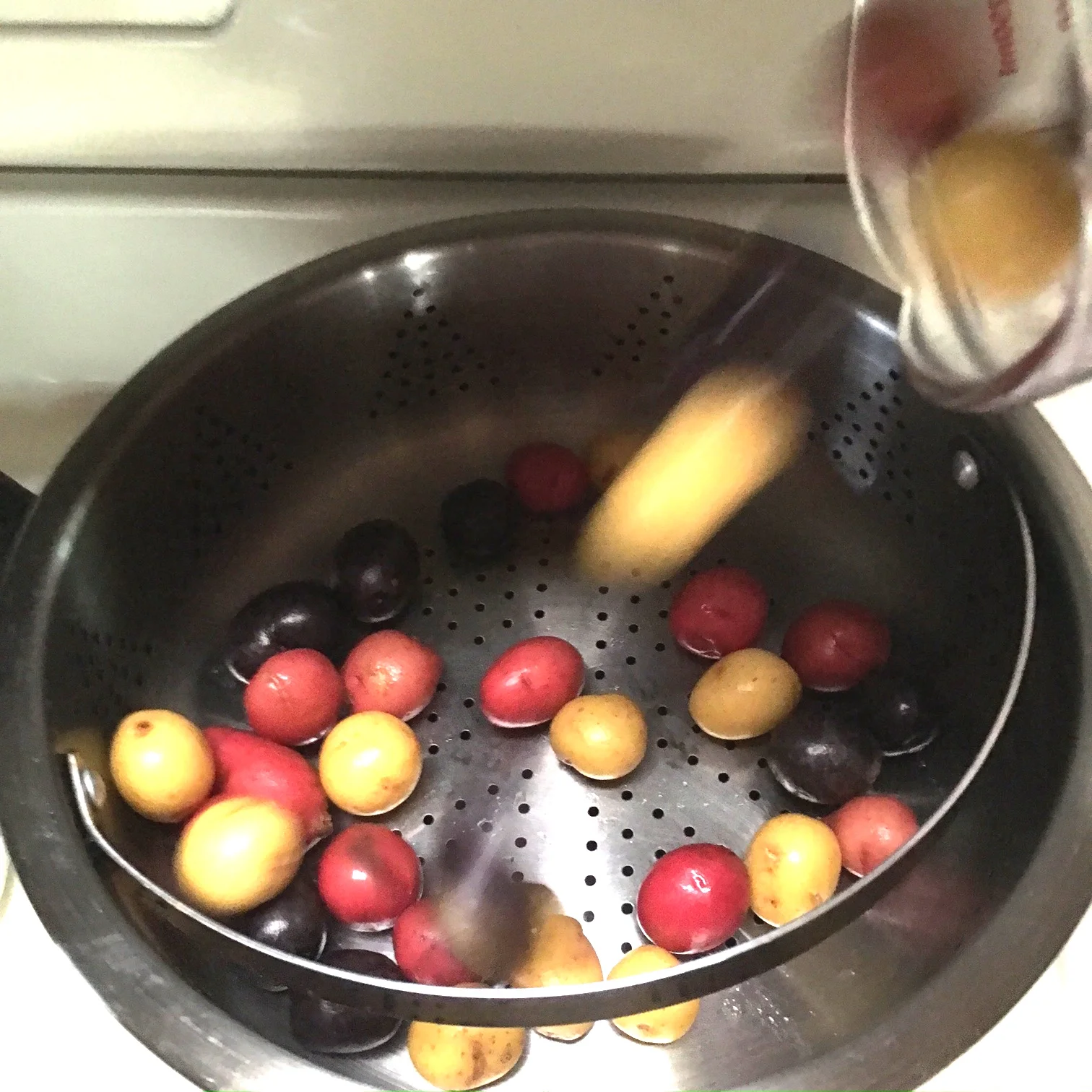    tossing small potatoes in steamer basket...   