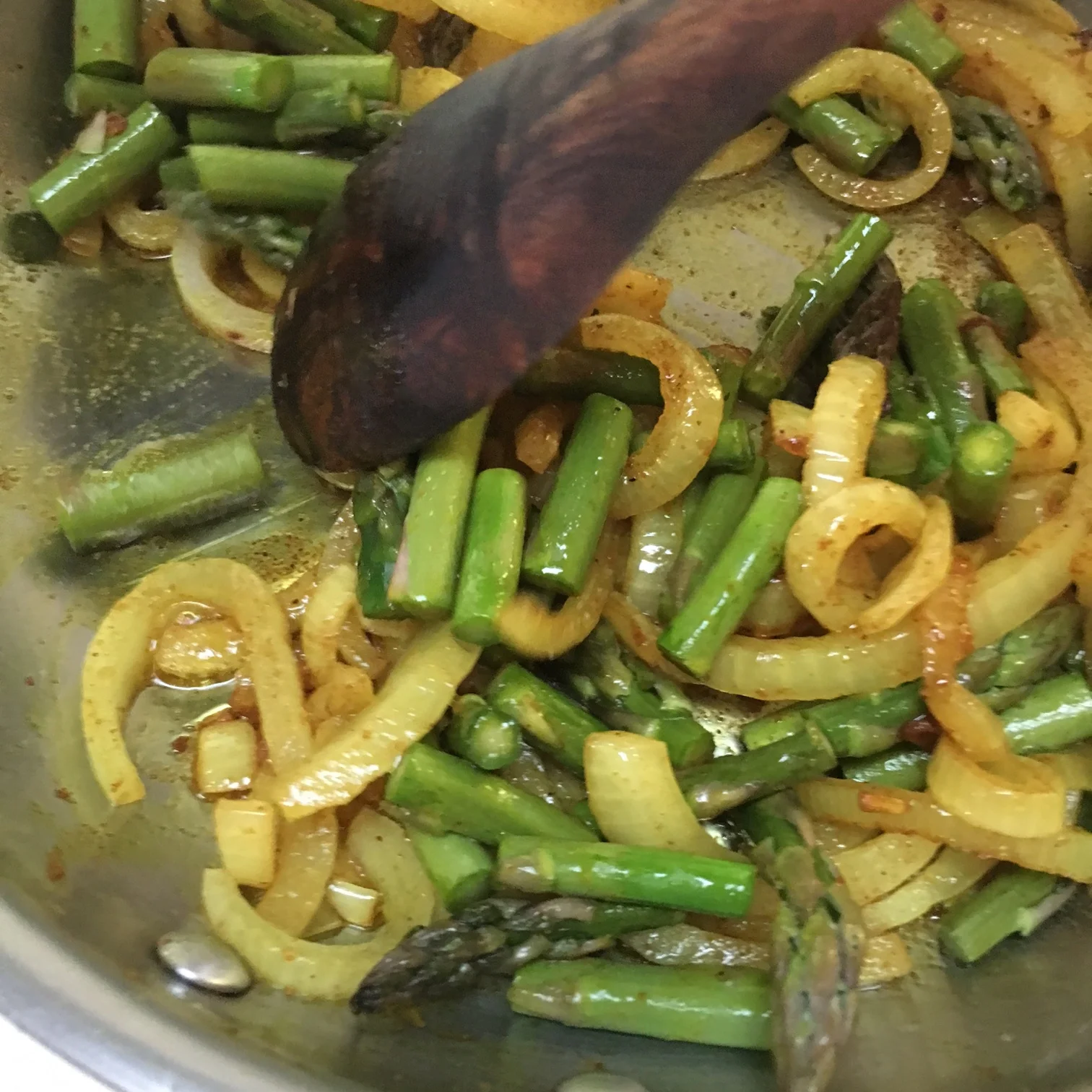    stirring sauteed veggies with a wooden spoon...   