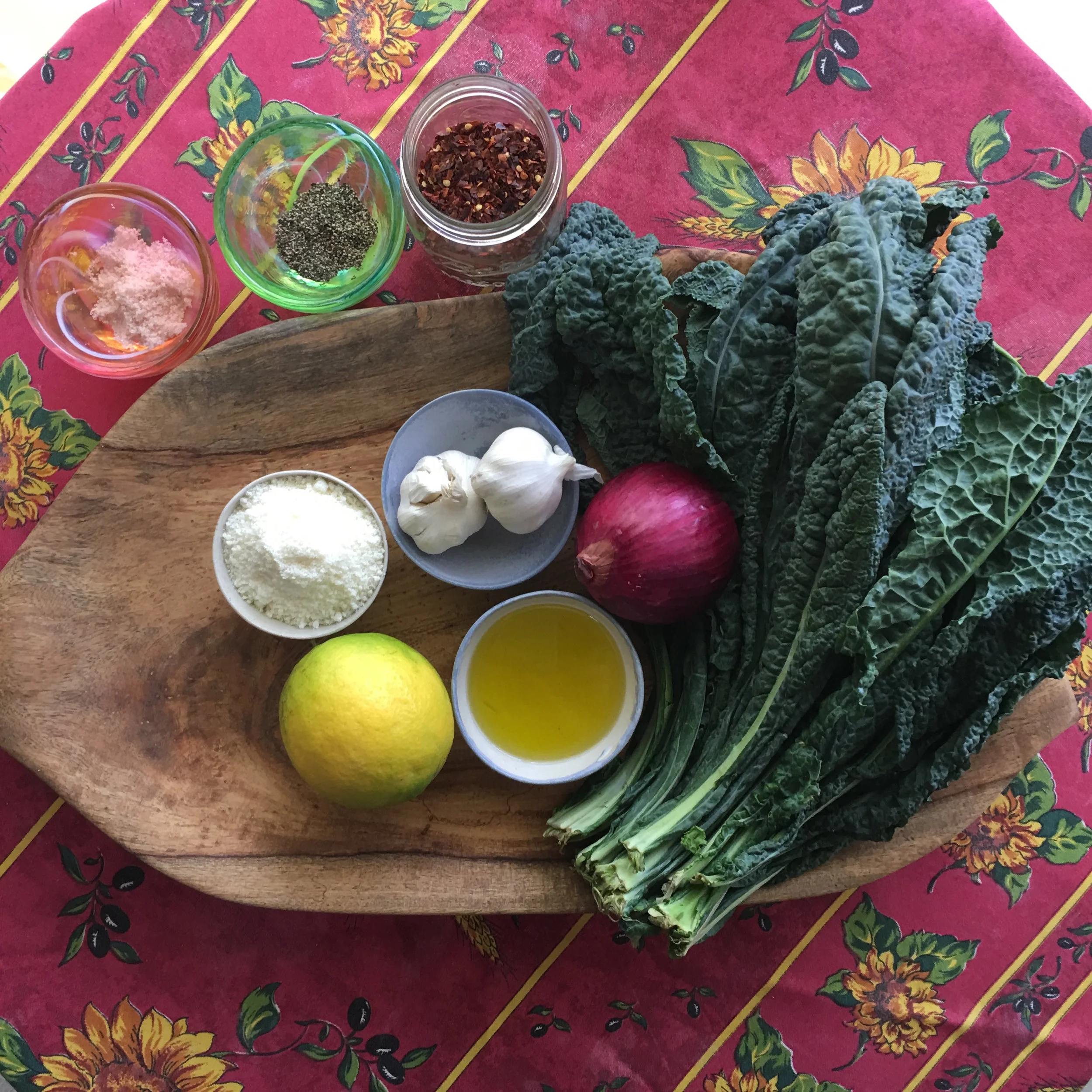    ingredients for Kale Caesar salad: flat leaf lacinato Tuscan kale, lemon, red onion, garlic, cold-pressed extra virgin olive oil, parmesan cheese, sea salt, black pepper...(chile flakes, optional)...   