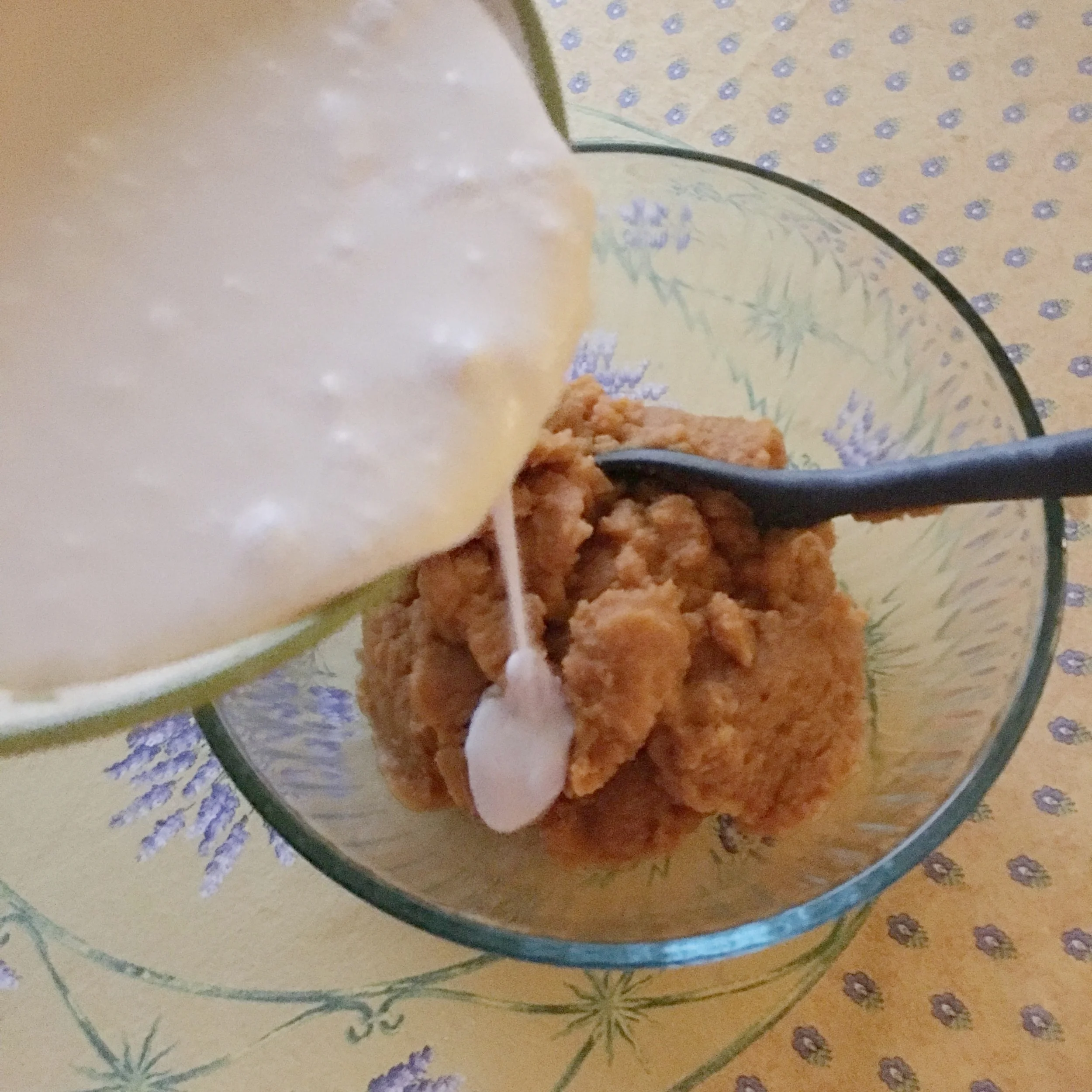    adding coconut milk to pumpkin puree in mixing bowl...   