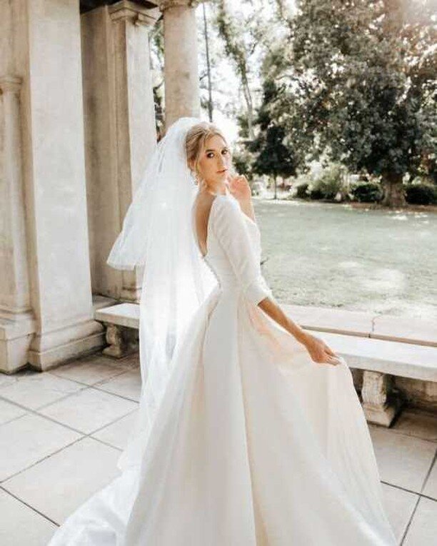 It was a showstopping moment for sure! Not all brides dare to use a statement veil, but Sydney chose one with several cascading levels. The mix of this flowy style in the back and simple A-line skirt made her dream custom dress come true.

PH: @nicol