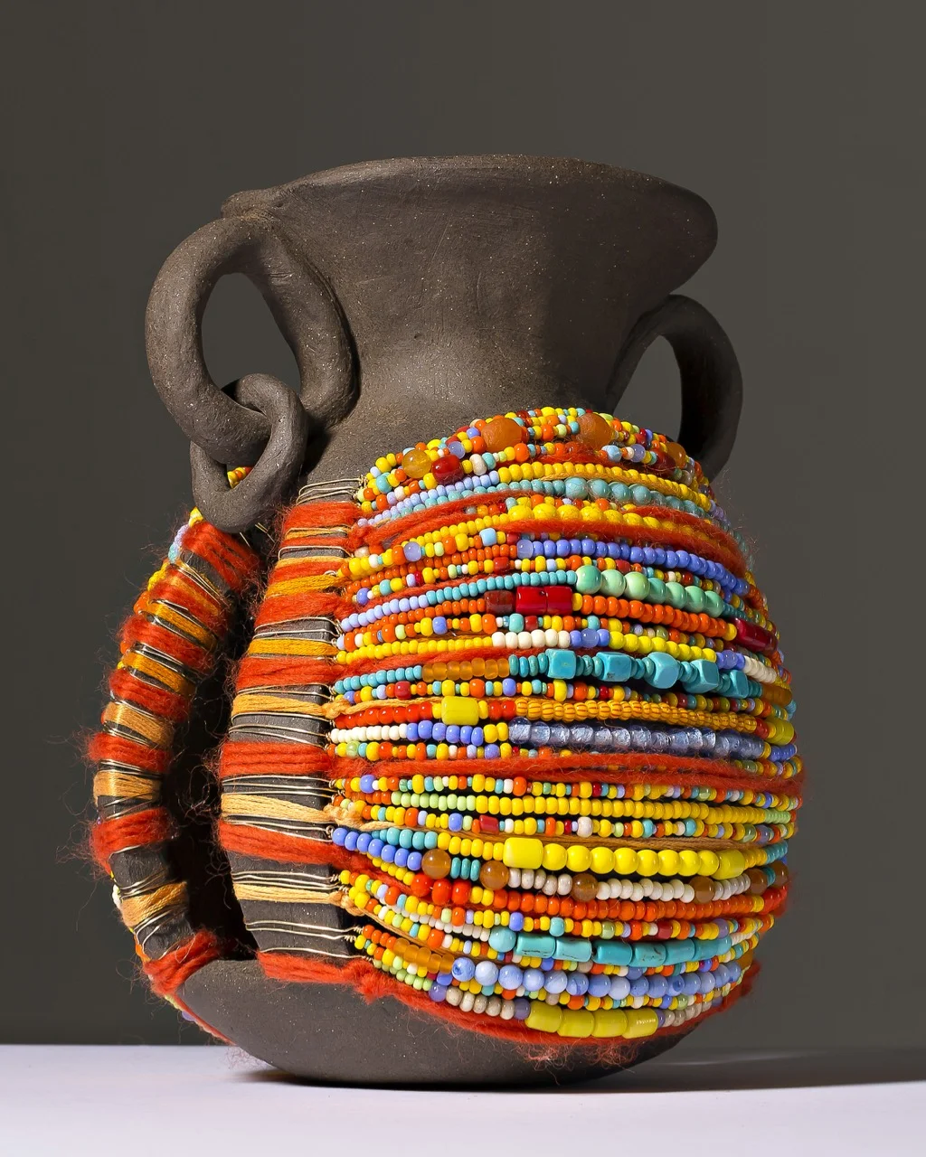 "Adorned Vessel in Yellow", ceramic, yarn and beads, 2015