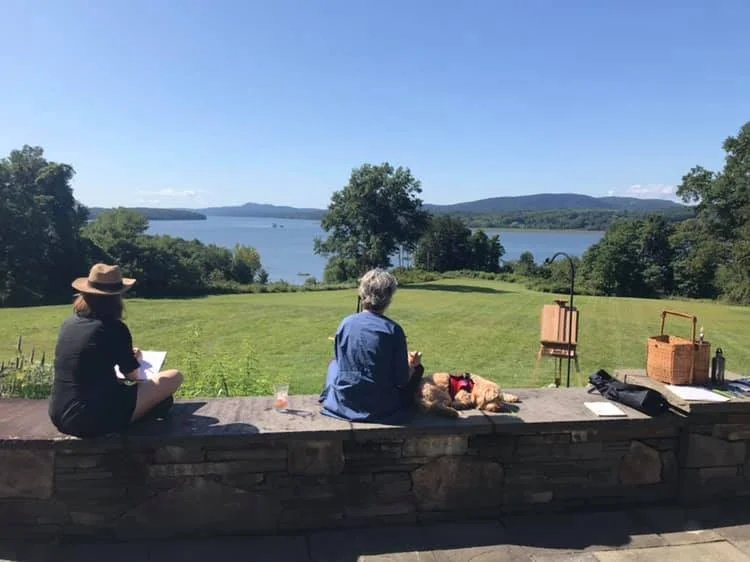 Students, sketching in a bucolic setting.
