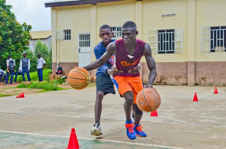 Ascend players running a dribbling drill through cones