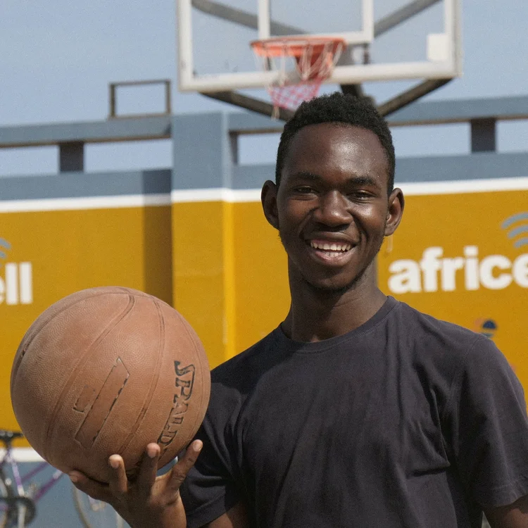 Kebba Faal holding a basketball