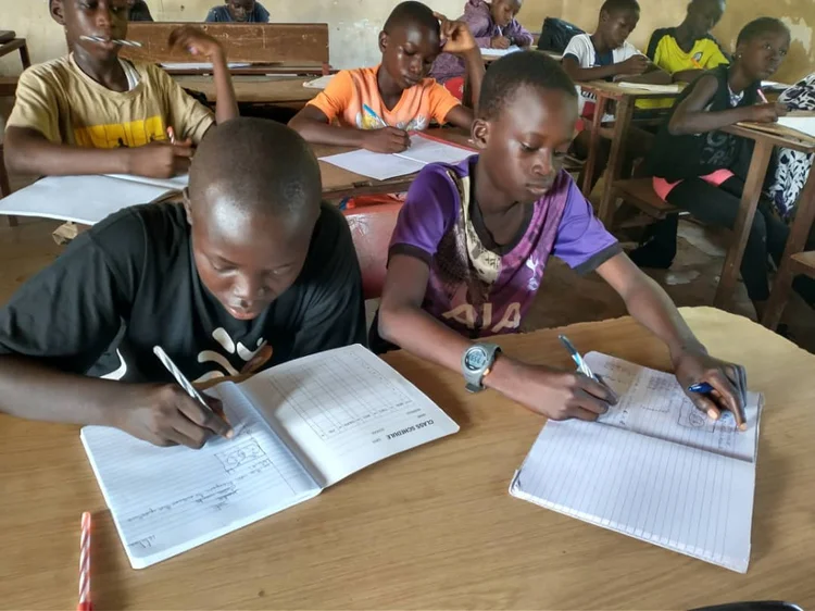Ascend students writing in their notebooks during a tutoring session