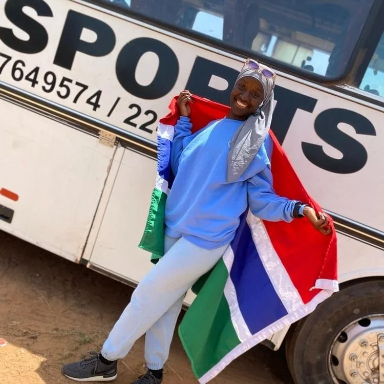 Bintou Dembelle with a Gambian flag