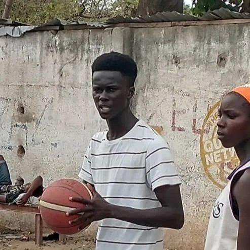 Abdou Wahab Njie holding a basketball