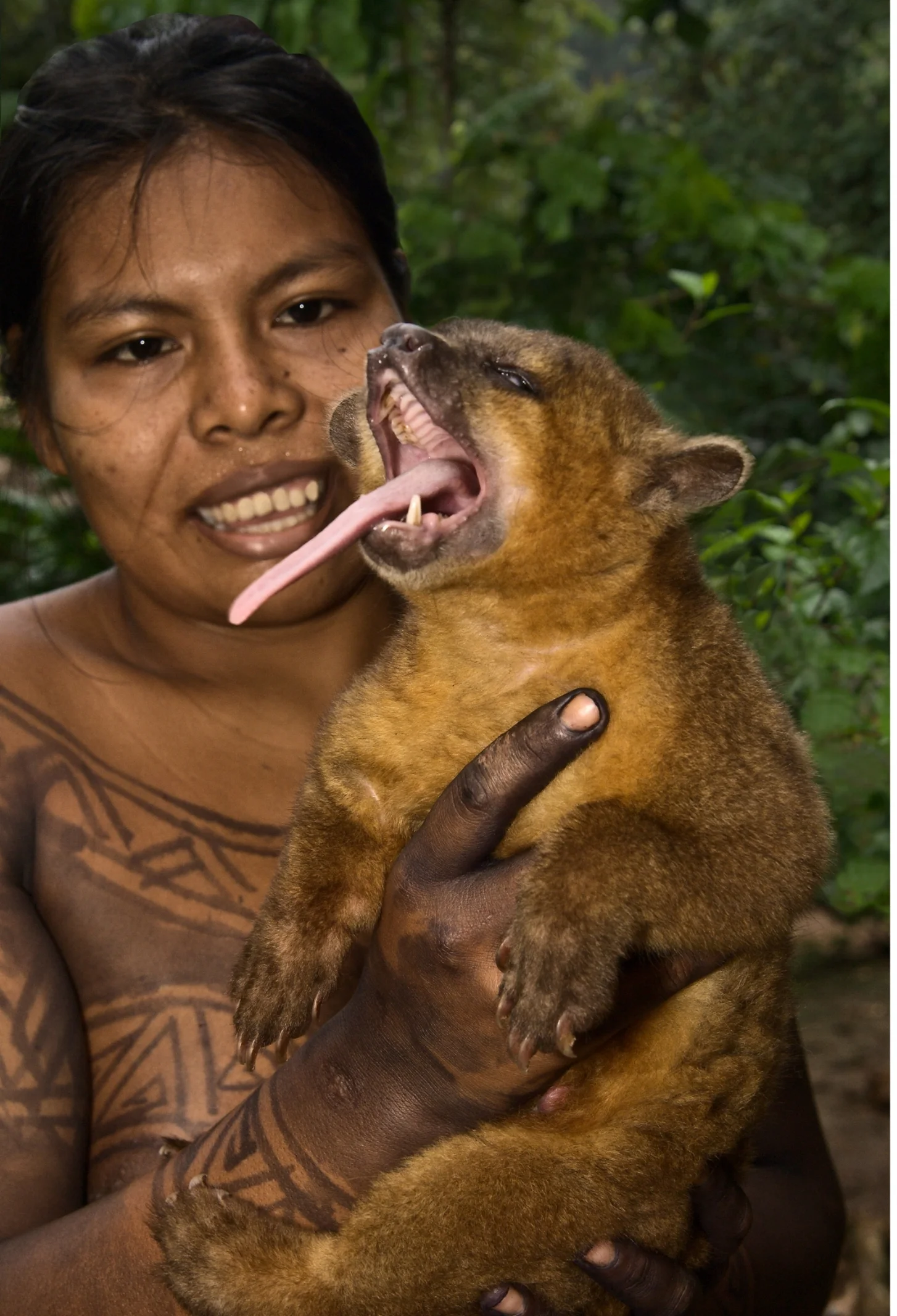 Indian woman with semi-permanent body painting. She's holding a kinkajou, also known as a "honey bear."