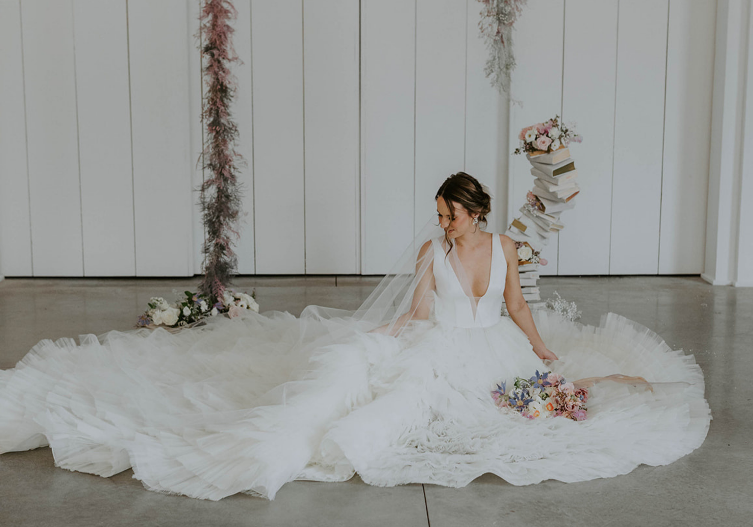 bride wearing Rivini Ross ruffle tulle wedding dress