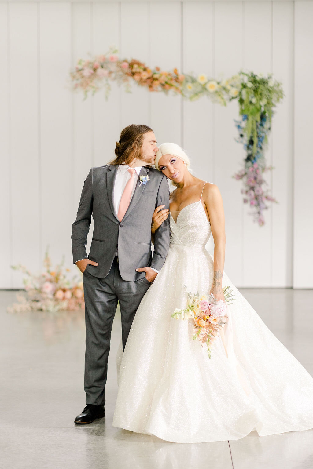 Bride and groom portrait. Bride is wearing Sparkle by Monique Lhuillier.