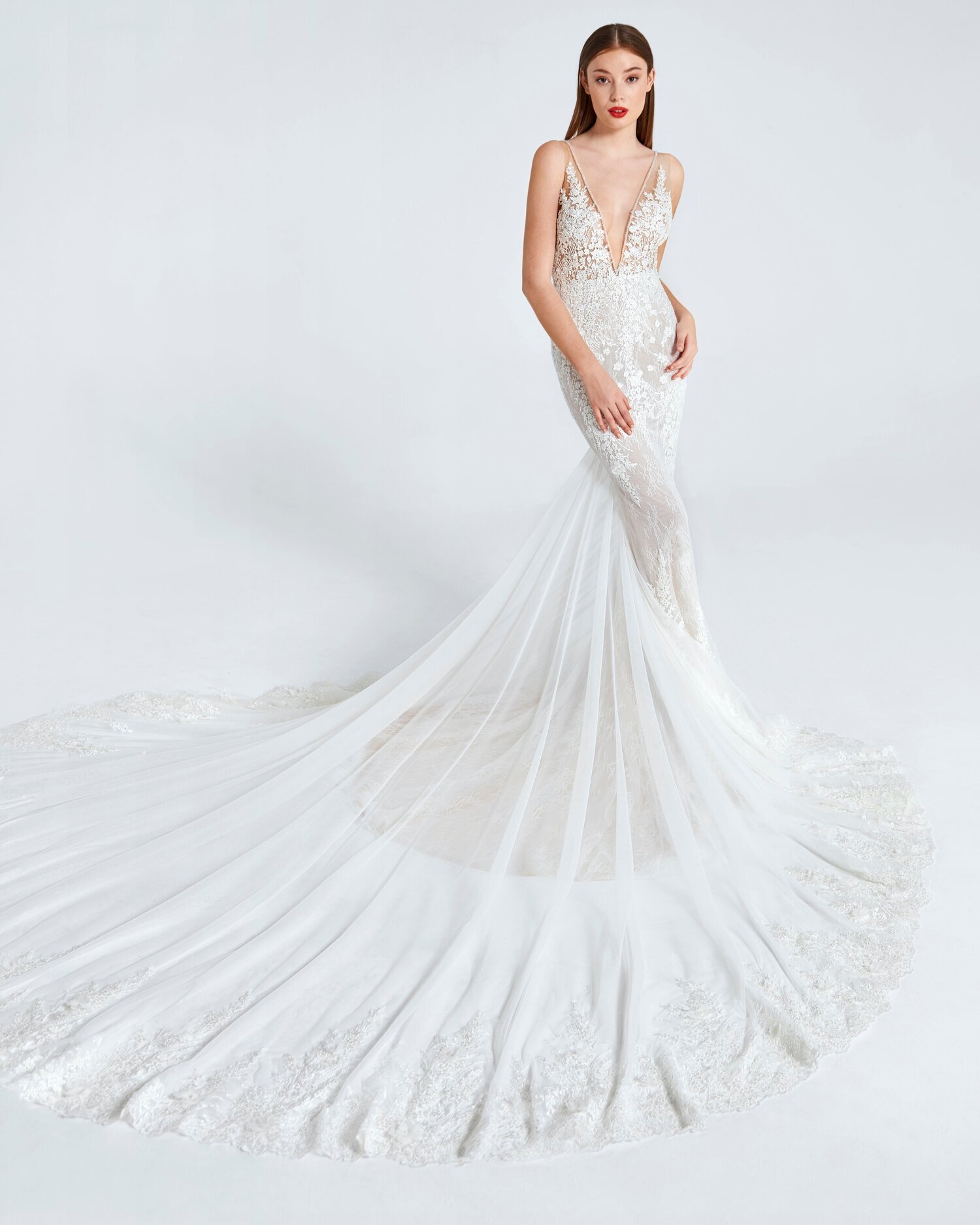 Flirty by Ines Di Santo. Luxurious, fitted wedding dress with deep v-neckline and lace detailing. 