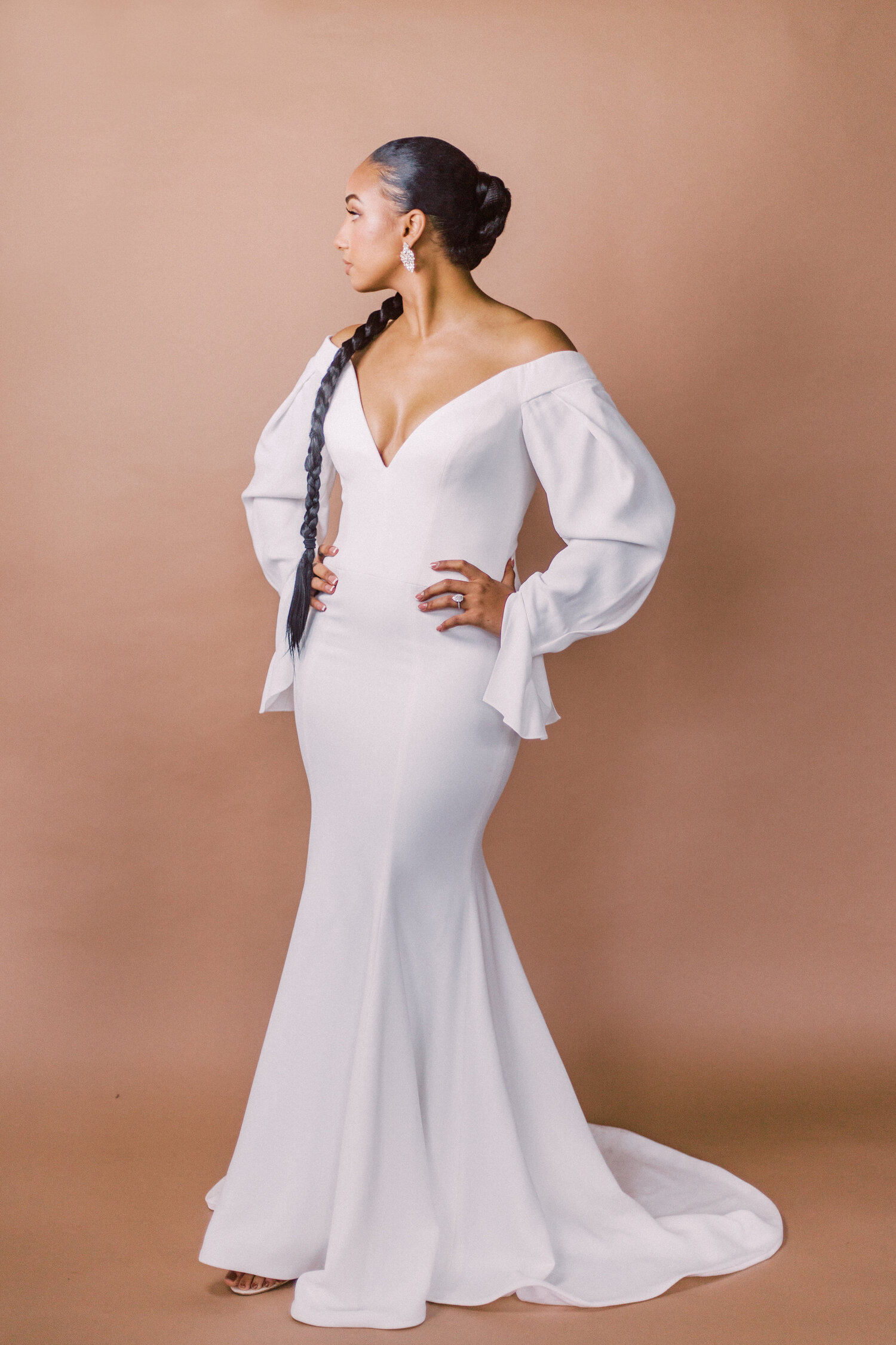 Luxurious off-the-shoulder long sleeve wedding dress by Vera Wang.