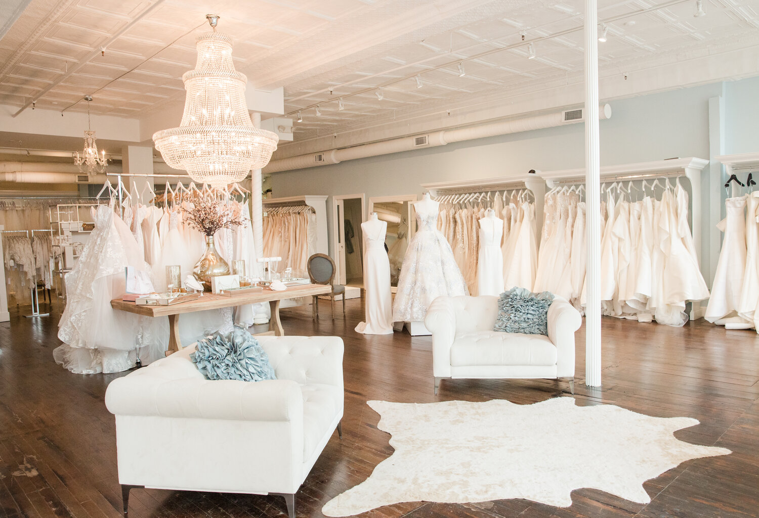 La Jeune Mariee Bridal Boutique in Columbus, Ohio. Boutique interior with wedding dresses and an elegant chandelier.
