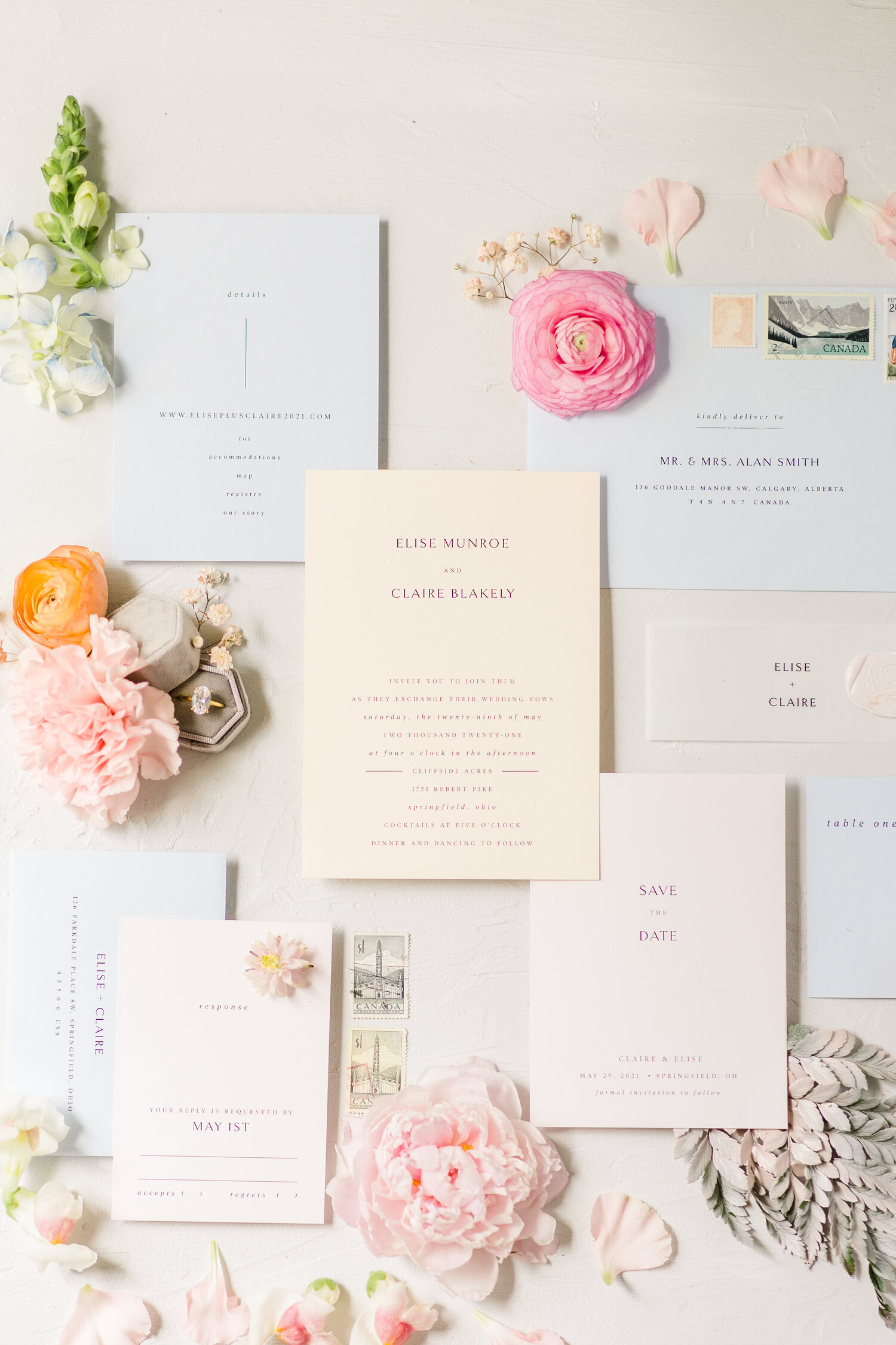 Pastel wedding details laid out in a flat lay.