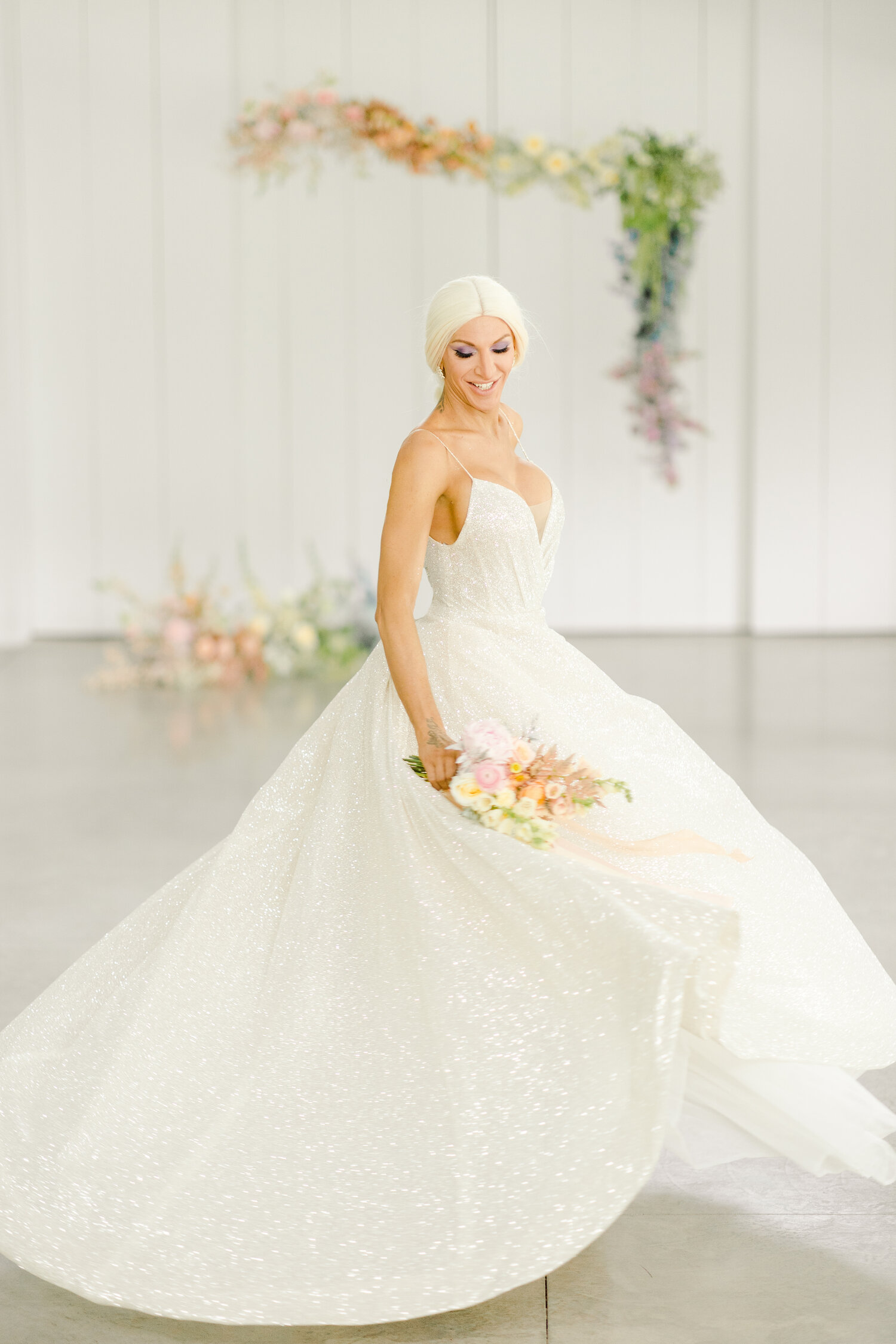Bride twirling in Monique Lhuillier Sparkle wedding dress. 