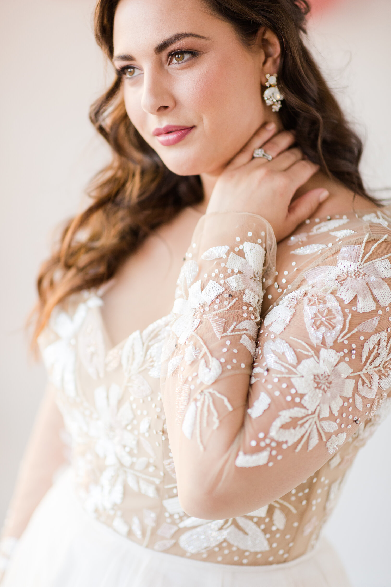 Bride wearing a long sleeve Hayley Paige wedding dress styled with Paris by Debra Moreland Accessories.