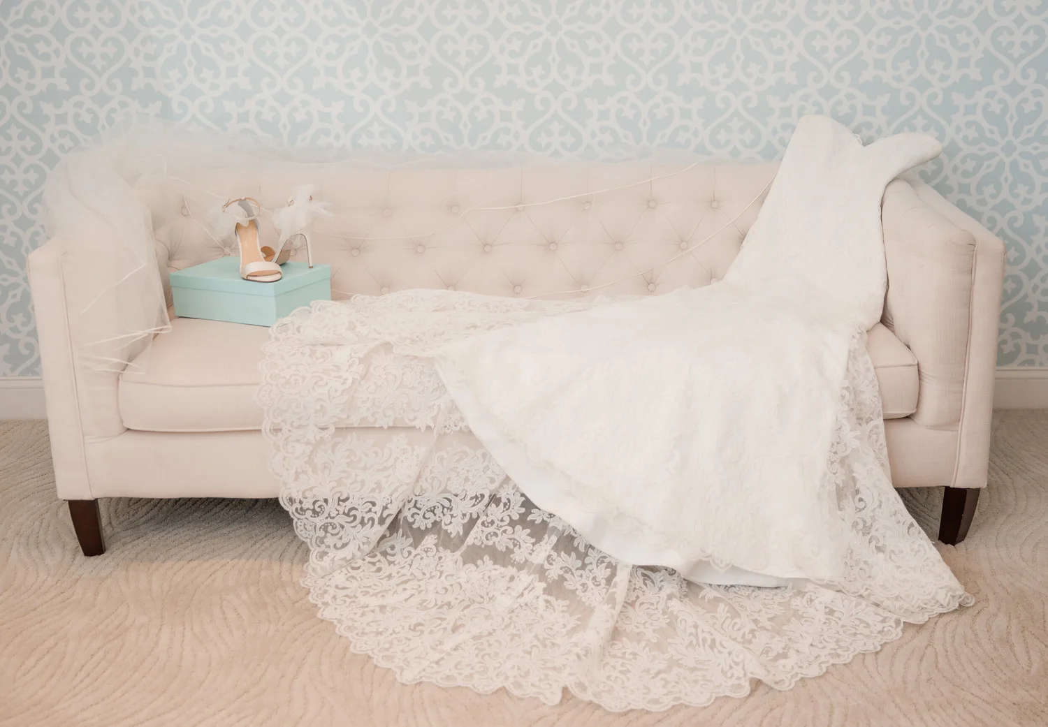 Fitted wedding dress with veil and bridal shoes at La Jeune Mariee Bridal Boutique.