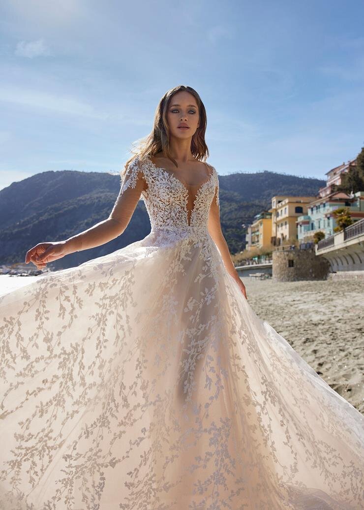 Model wearing Ines by Ines Di Santo Mirri long sleeve A-line wedding dress.