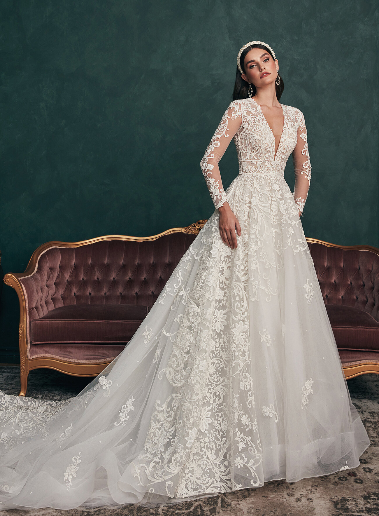 Model wearing Calla Blanche Saint long sleeve lace ball gown wedding dress.