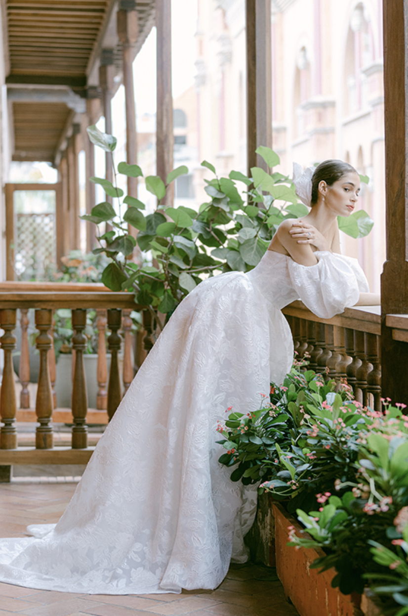 woman wearing Monique Lhuillier Fernanda lace ball gown wedding dress with detachable sleeves