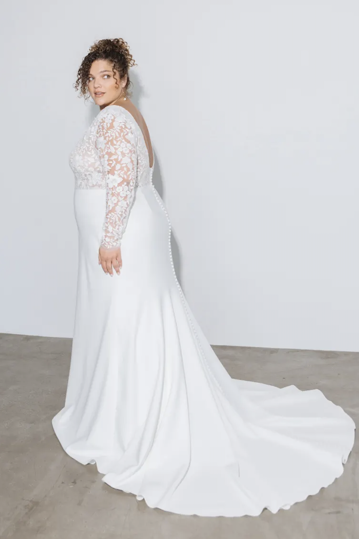 woman wearing Jenny Yoo Julian long sleeve lace wedding dress