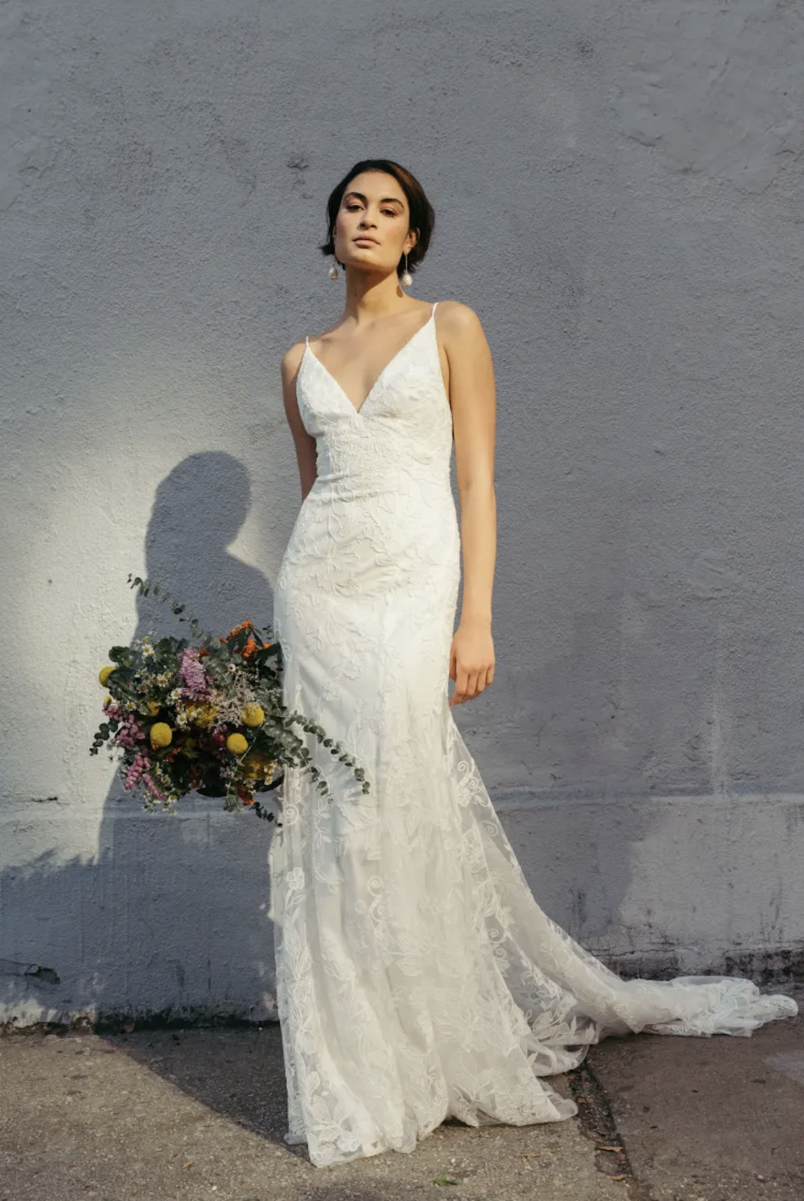 woman wearing Jenny Yoo Tensely fit and flare lace wedding dress