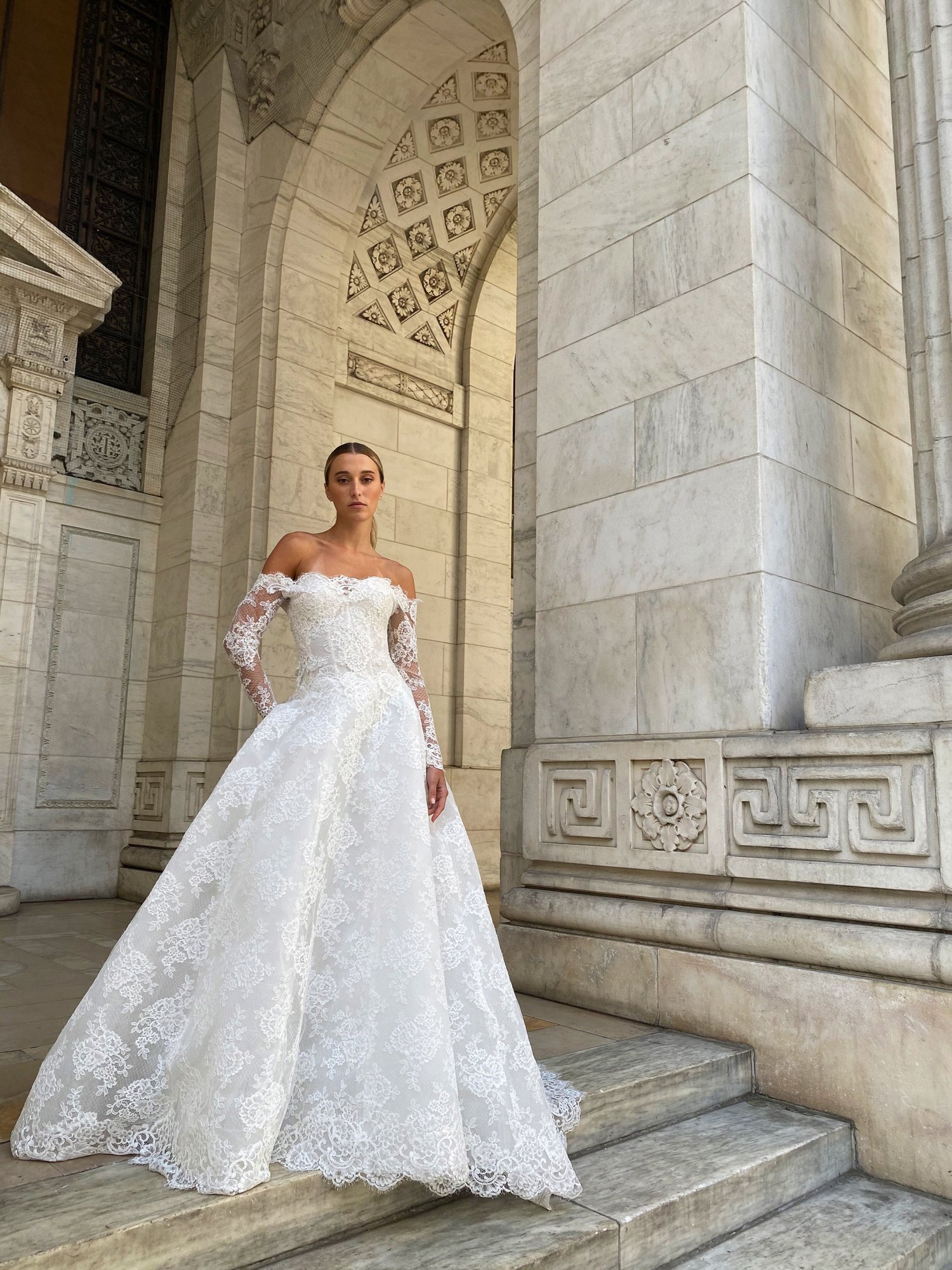 woman wearing Monique Lhuillier Fleur de Lis drop waist wedding dress