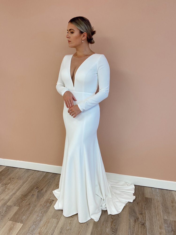 woman wearing Jenny Yoo Blythe long sleeve fitted wedding dress