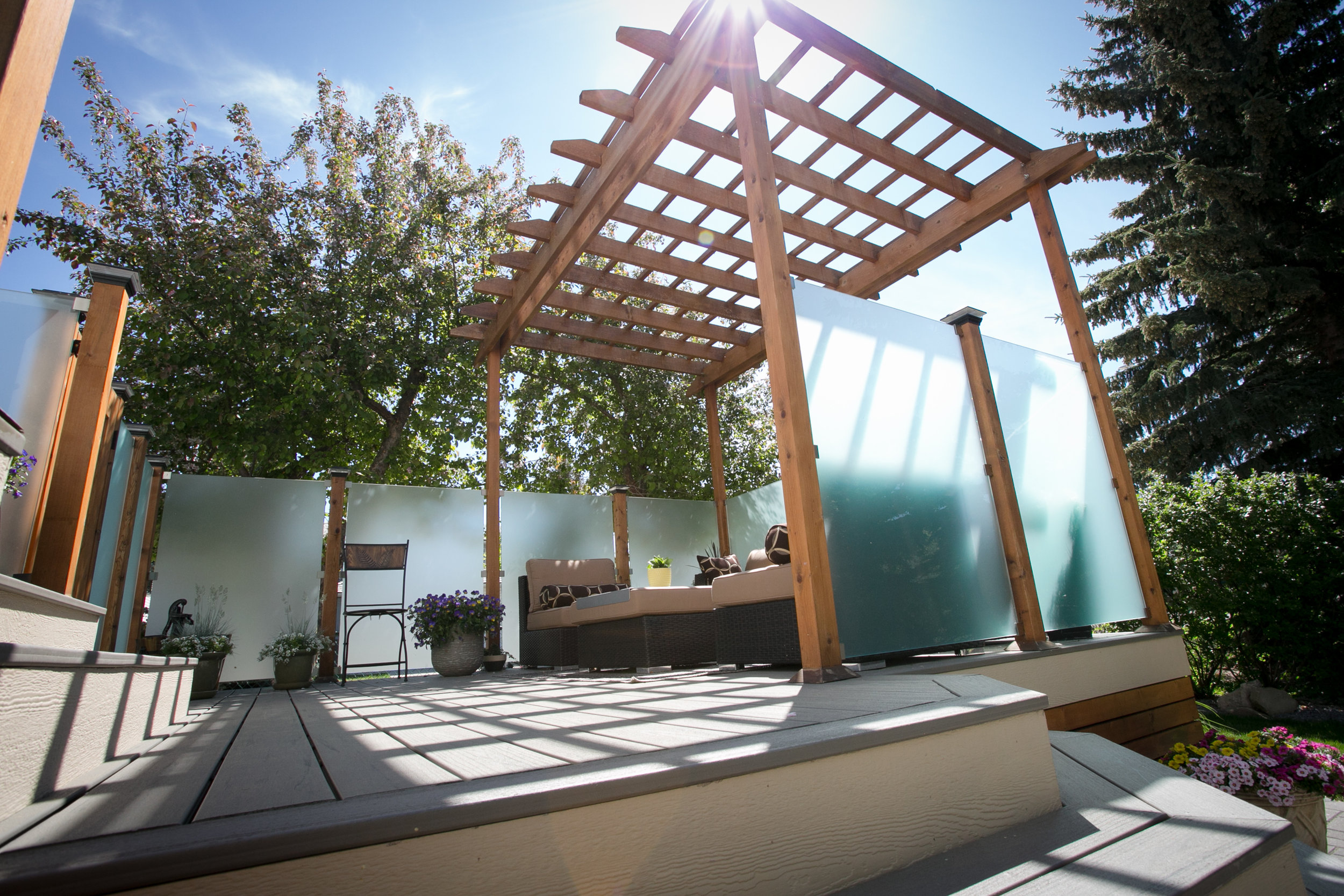  Composite decking, pergola and privacy panels with post-top lights — Valley Ridge, Calgary. 
