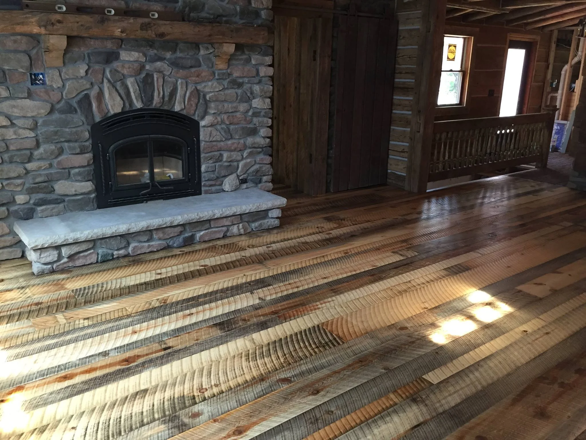 Circle sawn pine hardwood flooring in a rustic log home.