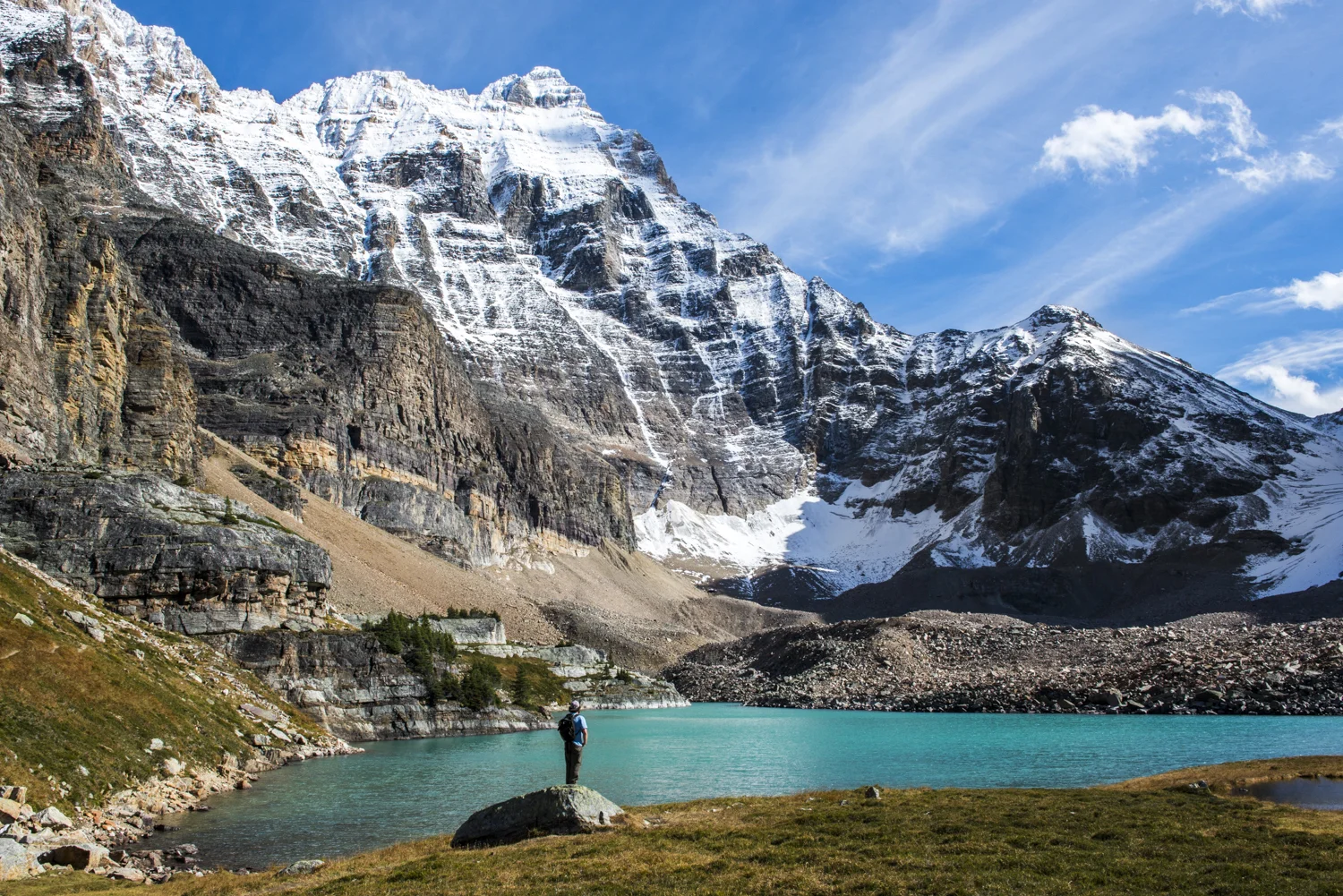 A hiker enjoys views of Lake Opabin in Yoho National Park.