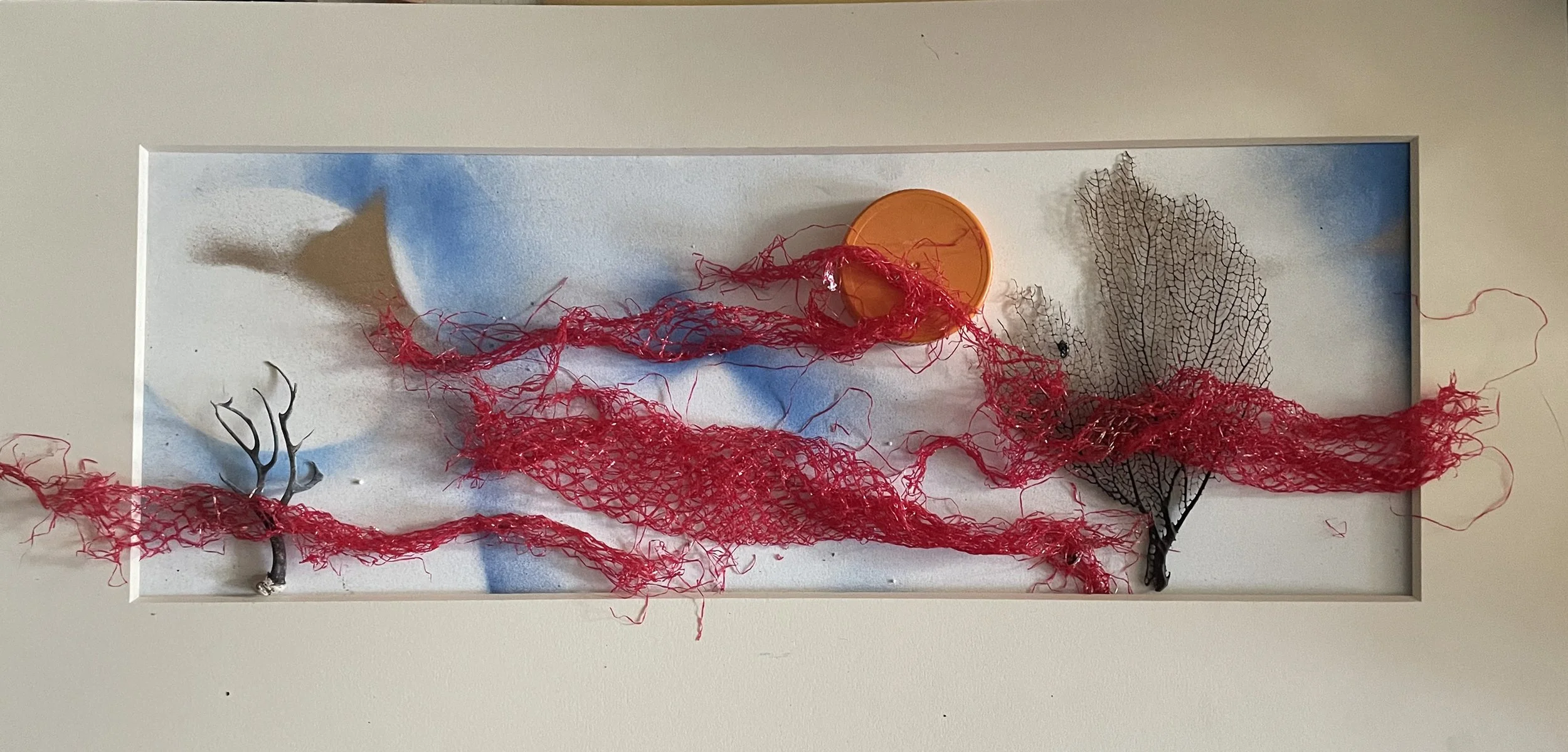 Vernita Nemec, _Playful Sunset_, 2024, 13_h x26_w x 1_ deep, upcycled plastic mesh bag, uncycled vitamin bottle cap, seaweed fossils, acrylic, museum board.jpg