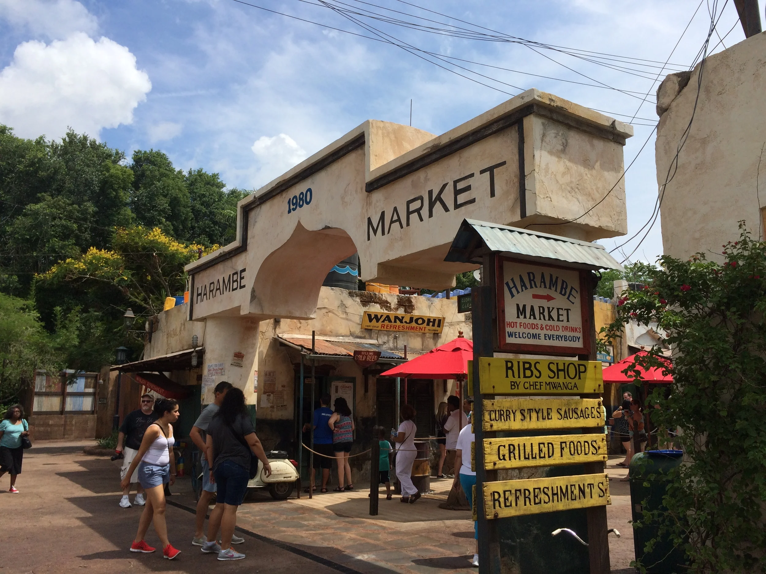 I am loving how the entrance plays into the storyline of the Harambe Village! Beautiful work!