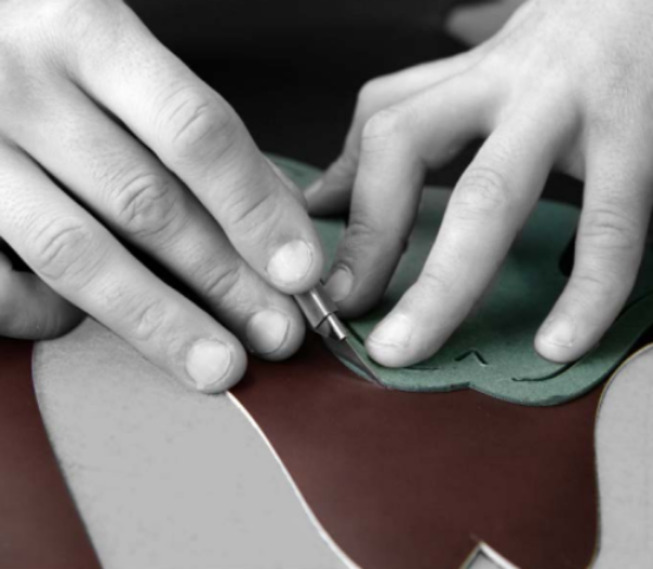 STEP 2 - CUTTING THE VAMP - The vamp, or upper, is the top part of a shoe, consisting in a moulded piece that is sewn to the sole. Cutting (or “clicking”) the vamp is a task that only a true expert who is deeply familiar with leather can perform with the necessary care, using only the finest part of the hide. During the operation, the cutter must follow the “grain”, i.e., the texture of the leather, to make the shoes as supple and durable as possible. Selecting the best sections of leather also entails a greater degree of waste, and thus higher production costs. 