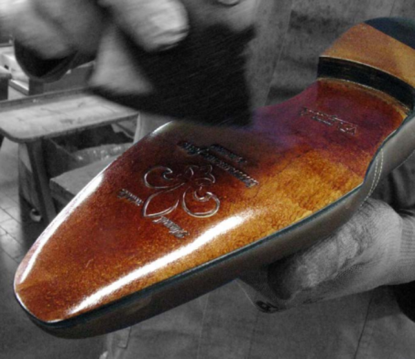 STEP 7 - FINISHING THE SOLE - Finishing consists in a series of operations that are carried out at the end of the production cycle. In this process, both the edges and underside of the sole are hand-finished using all-natural stains and waxes. This operation is a lengthy one, between brushing and staining with one or two pigments, but gives the shoe perfect breathability, flexibility and elegance. All of our soles are made of natural leather.