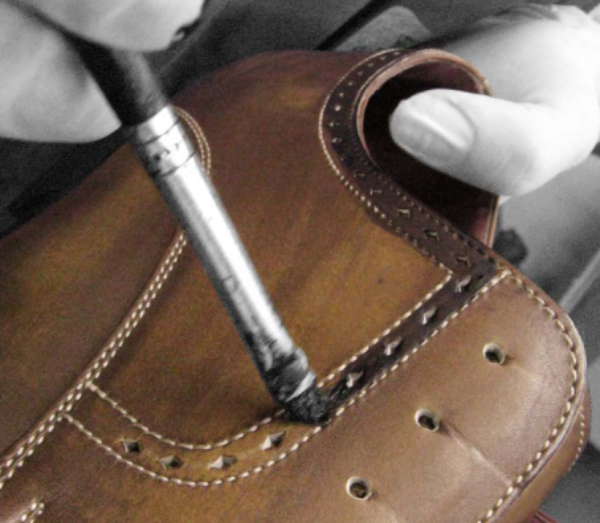 STEP 8 - FINISHING THE UPPER - The final operation, and perhaps the most important one, is finishing the upper. In order to restore the original characteristics of the leather (shine, softness, etc.) that are inevitably altered in making the shoe, the upper is washed with special, neutral detergents and then treated with waxes and natural creams. There are hundreds of kinds of leather, and many different processes for finishing it. Hand-aged shoes require an elaborate finishing process that makes them elegant, sophisticated, and uniquely appealing. The leather can be bleached in certain spots to create a motif along the seams, or for mottled or two-tone effects, fading from black to brown, etc. If you happened to see this stage, you’d find yourself entranced by the skill of our artisans, whose expert hands give each of our shoes its own unique personality.