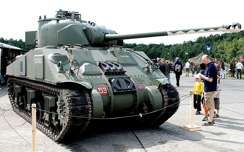 Thanks to the camouflaged barrel, not even this man and his kids realize the impending danger to their Panzer division.