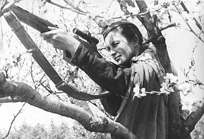 Pavlichenko on the job. Well, I think she probably got a bit cleaned up for the photo. She's holding an SVT-40 semi-automatic rifle. They didn't give those to just anyone.