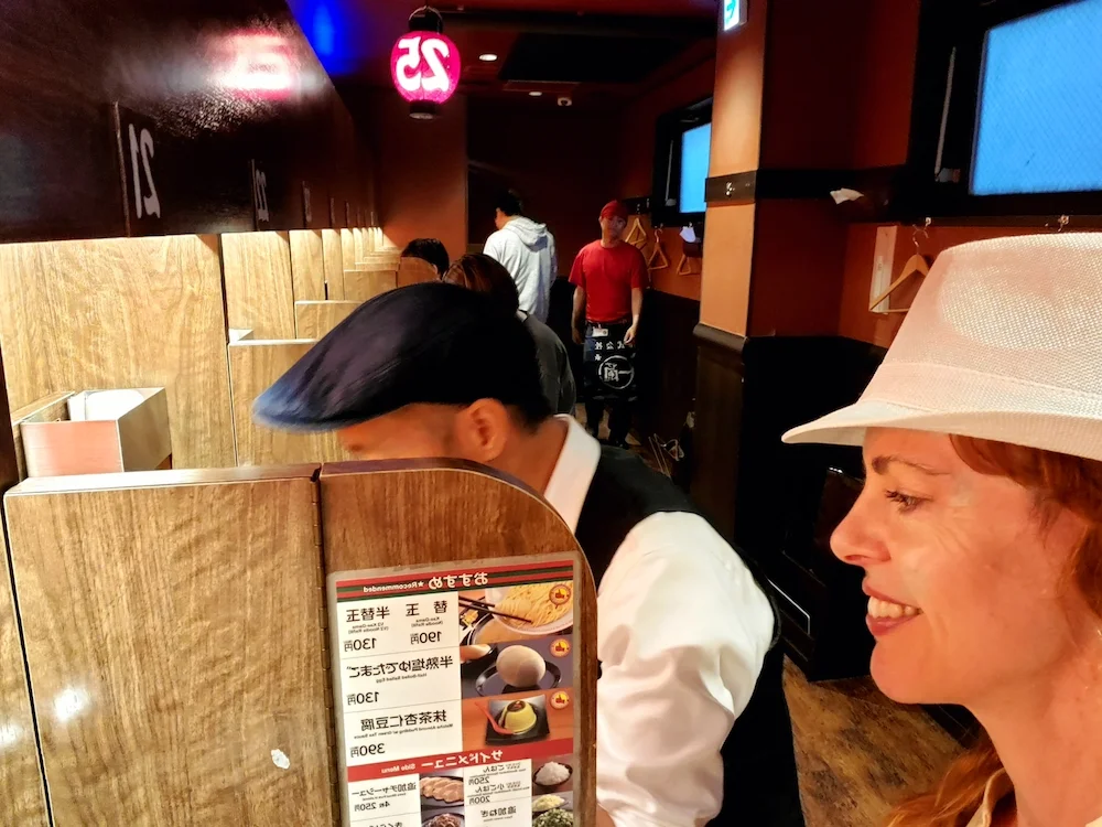 Richard & Selena at individual eating cubicles at Ichiran ramen bar.