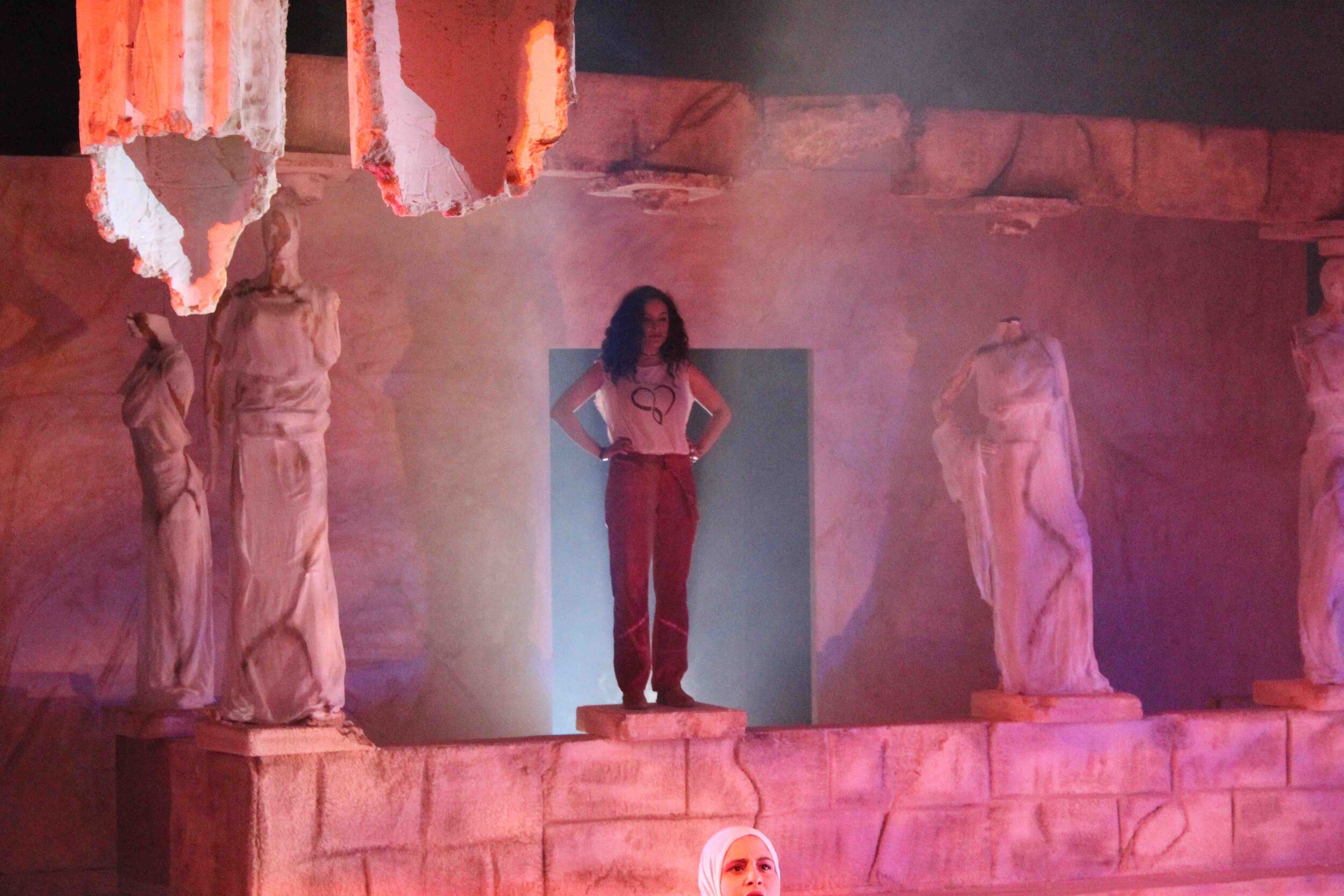 Lysistrata- Curtain opens revealing Lysistrata standing like a caryatid