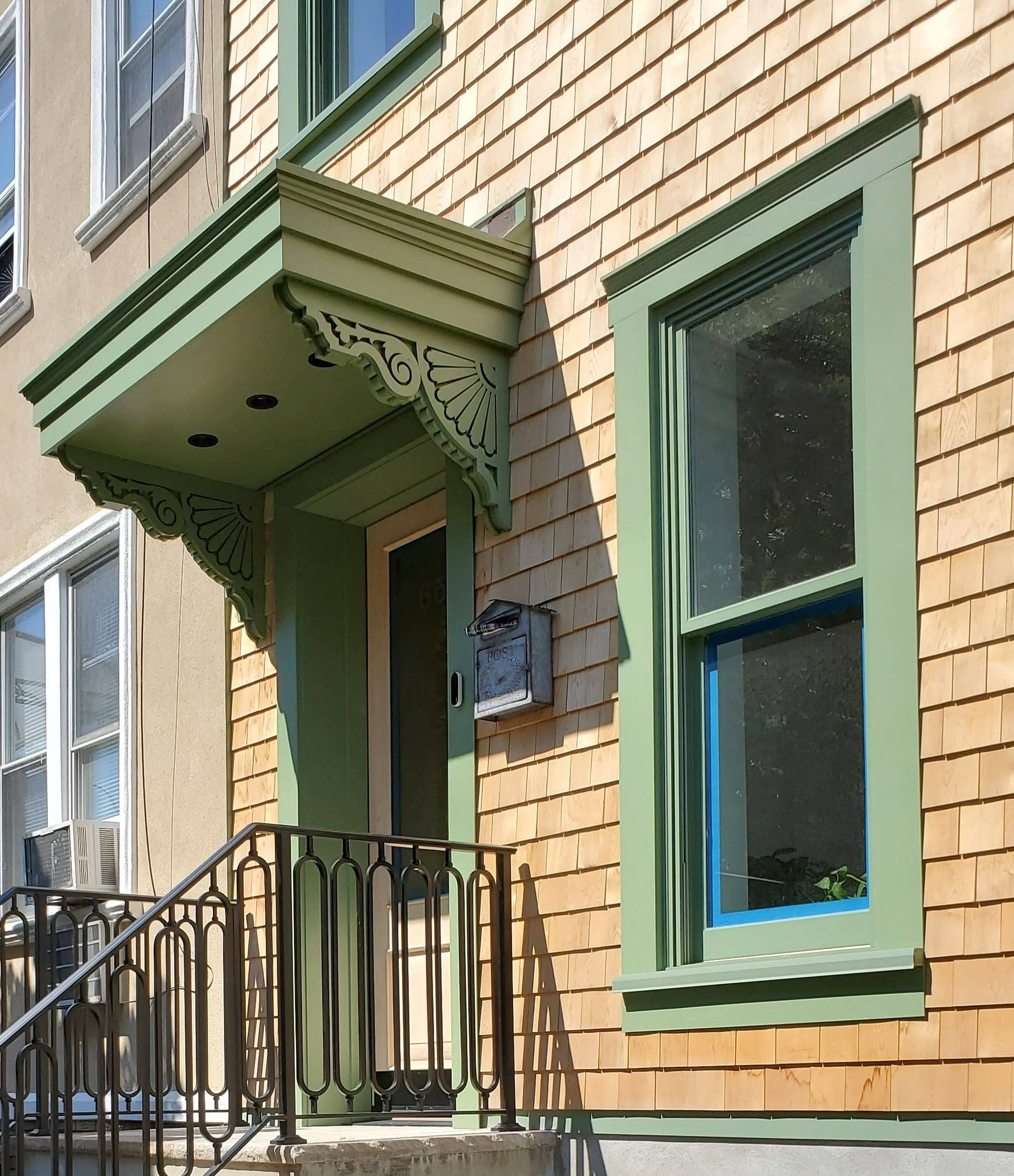 A new awning and cornice and new windows were added. Natural untreated cedar shingles were used both in the front and back facades. 
