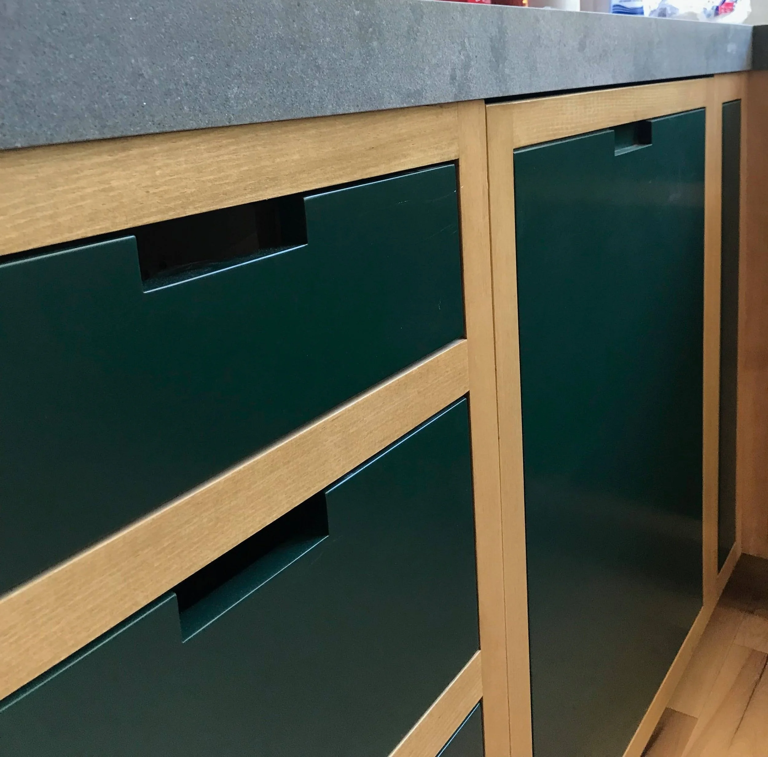 The kitchen cabinets, island, and shelves were custom-built using wood reclaimed from the original ceiling beams that required replacement.