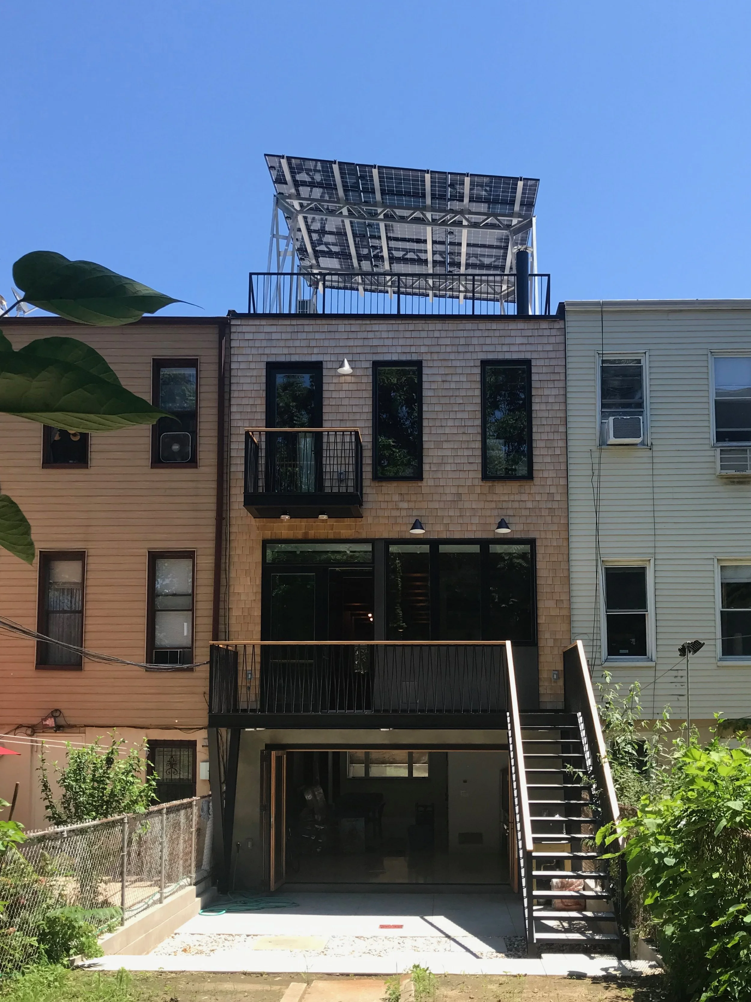 The back facade embraces a contemporary design. 
The solar panel canopy on the roof provides renewable electricity.